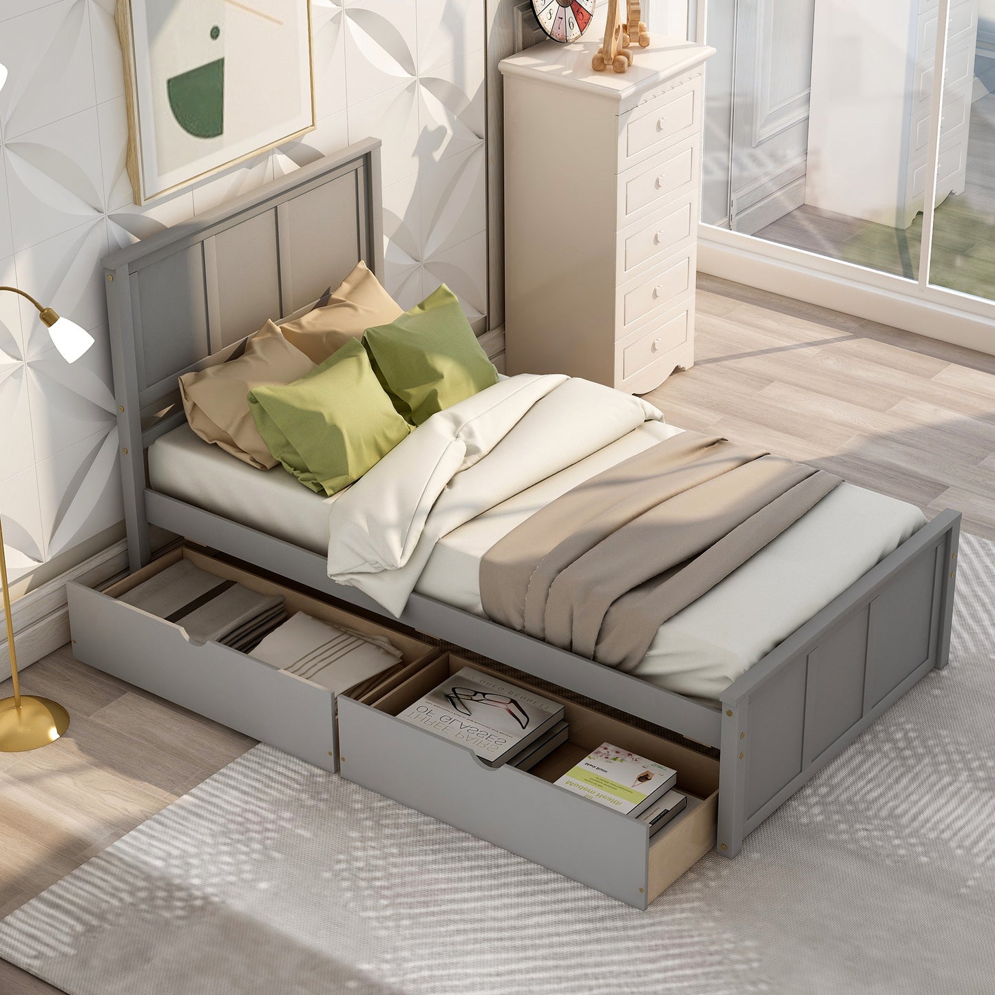 Grey twin bed frame with storage drawers and green pillows for a modern bedroom