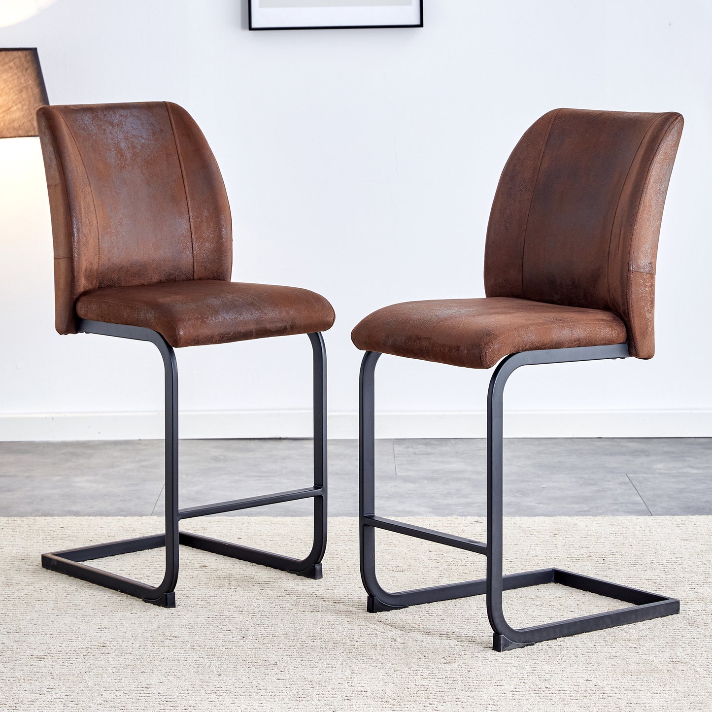 Brown faux leather cantilever bar stools with black metal frames