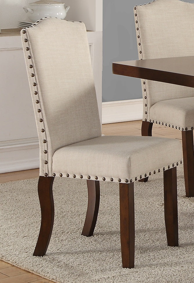 Tufted beige fabric dining chair with dark wood legs and nailhead trim