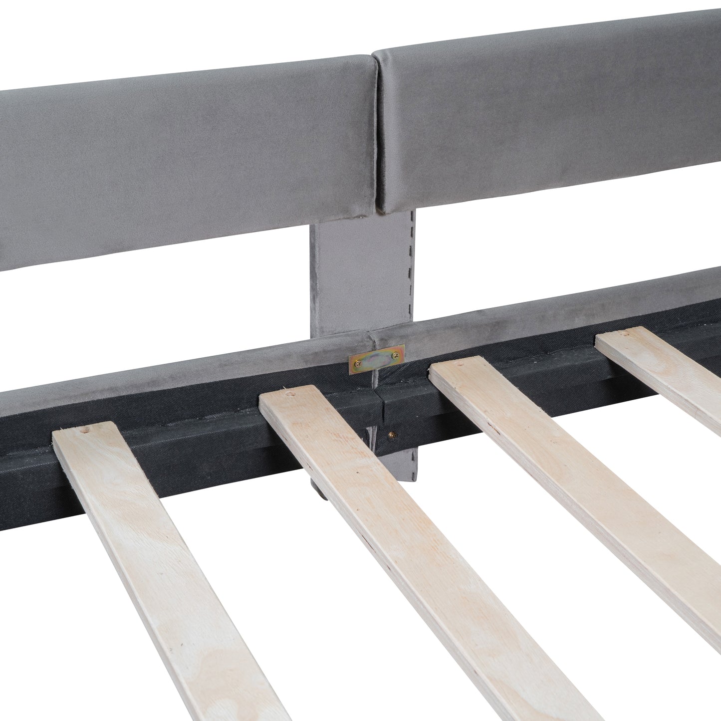 Closeup of a gray velvet bed frame headboard support structure and wooden slats for mattress