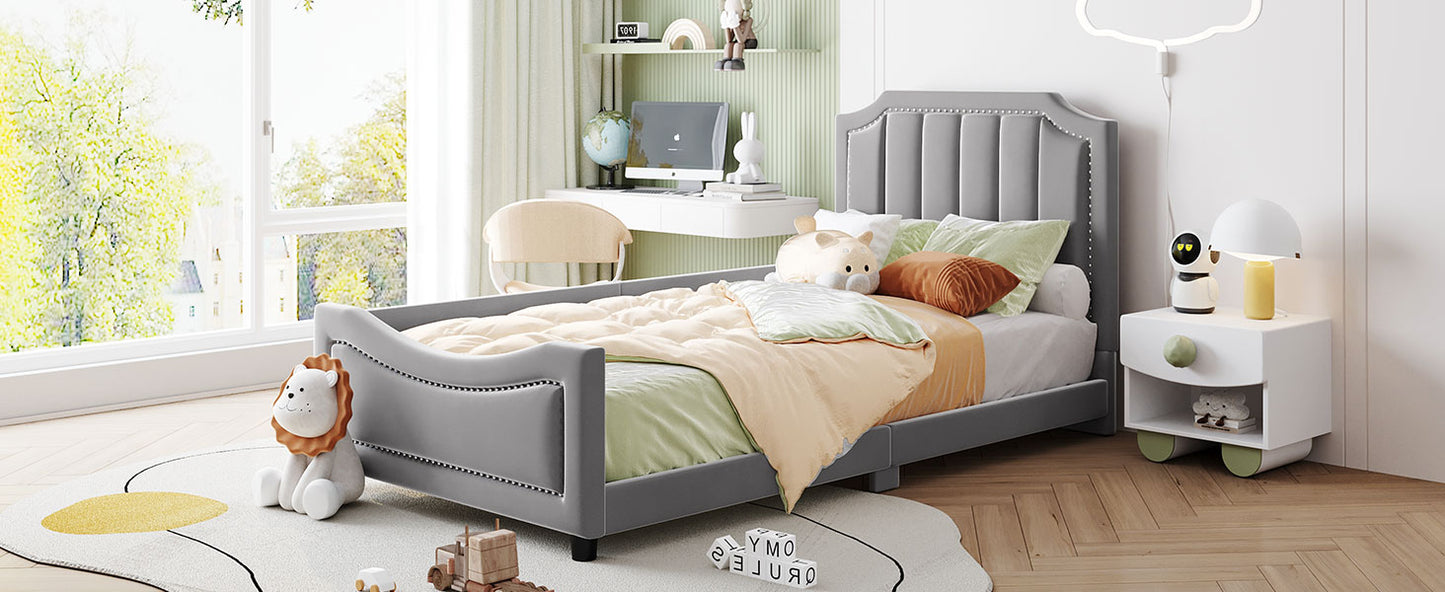 Grey upholstered twin bed with studded headboard for children
