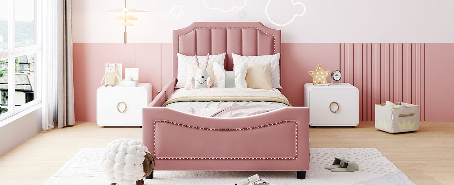 Pink velvet twin bed with studded headboard and footboard perfect for a childs bedroom