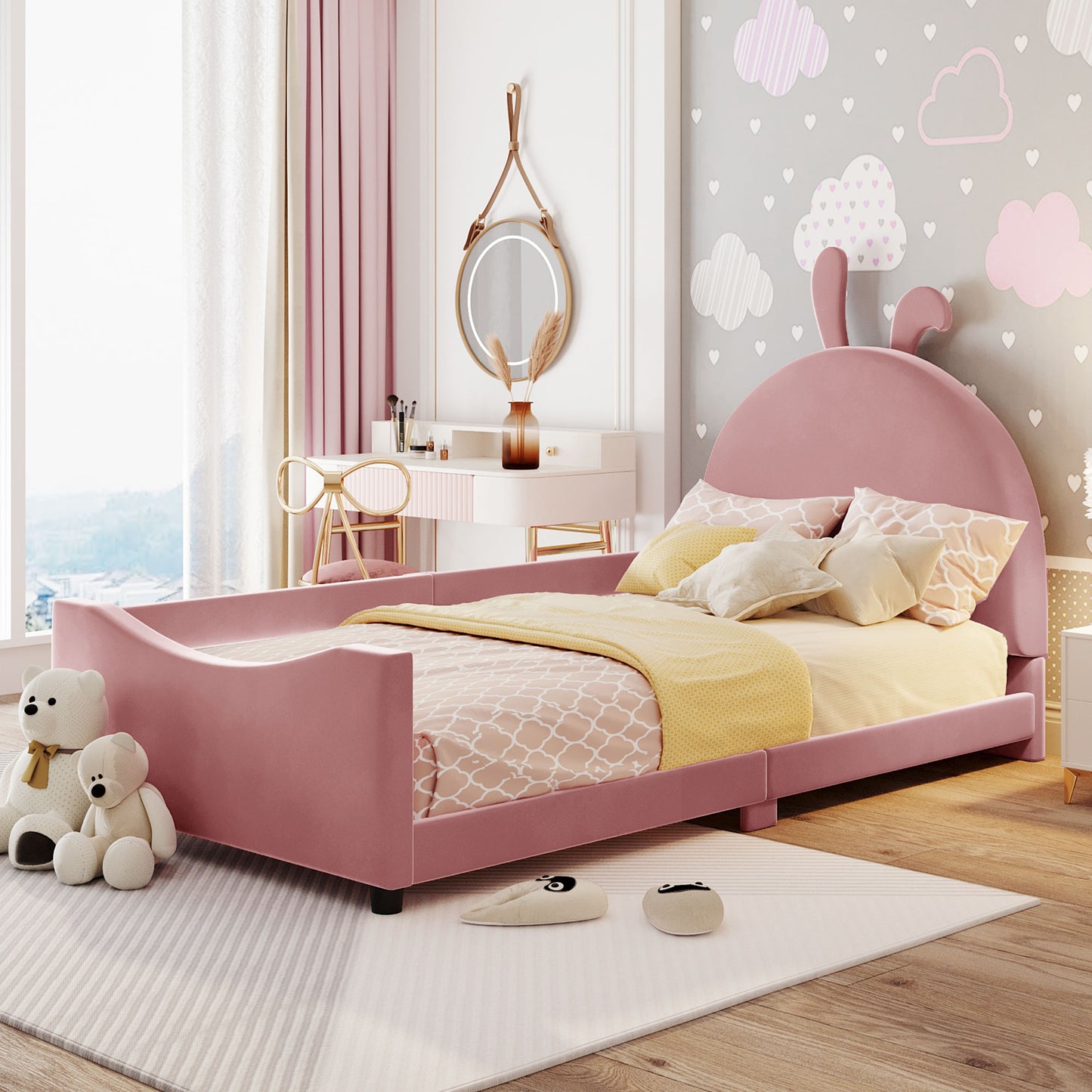 Pink velvet twin bed with bunny ears headboard and cloud patterned bedding