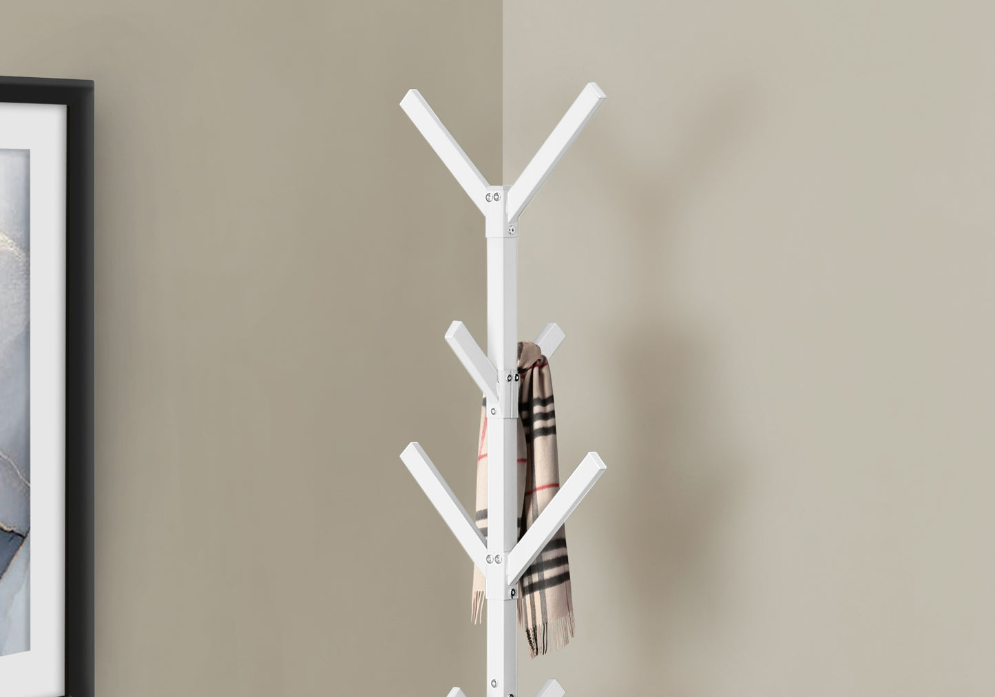 White modern coat rack displaying plaid scarf