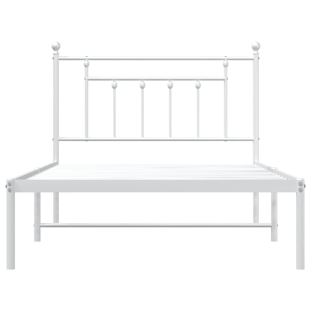 White metal twin bed frame with ornate headboard and mattress