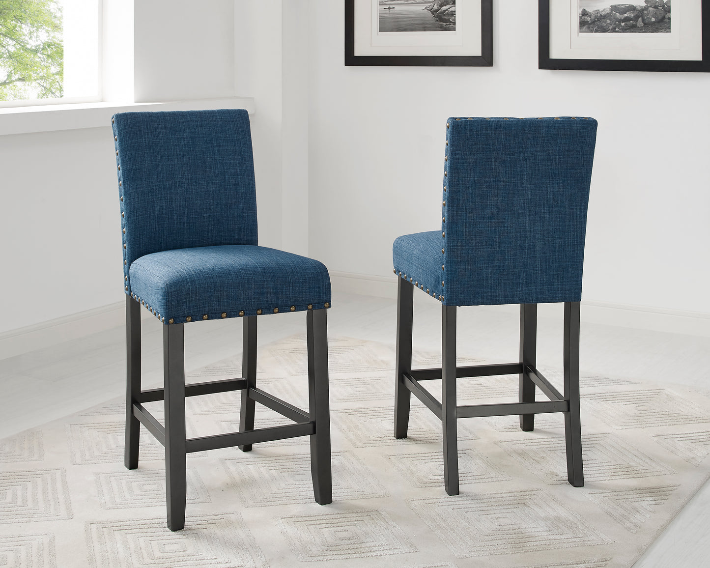 Blue upholstered bar stool with brass nailhead trim and dark wood legs