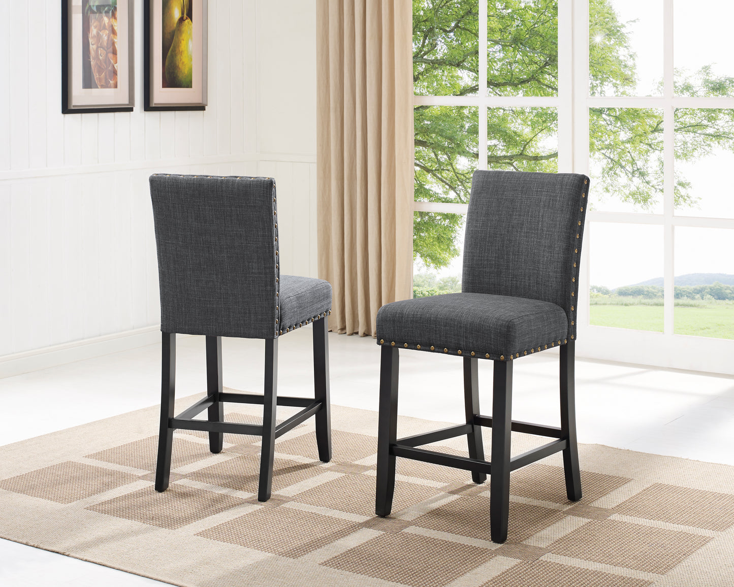 Dark gray upholstered bar stool with brass nailhead trim and black legs