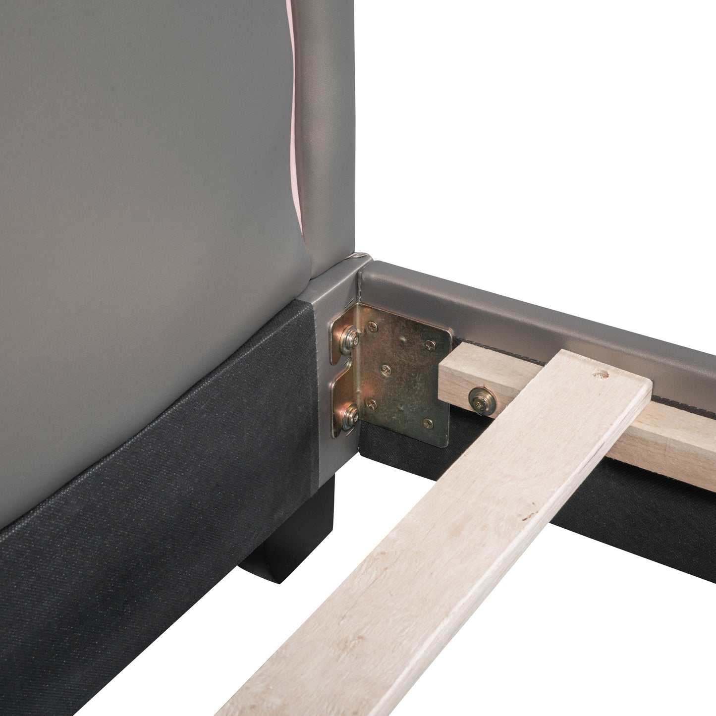 Closeup of upholstered bed frame corner with metal bracket and wooden slats