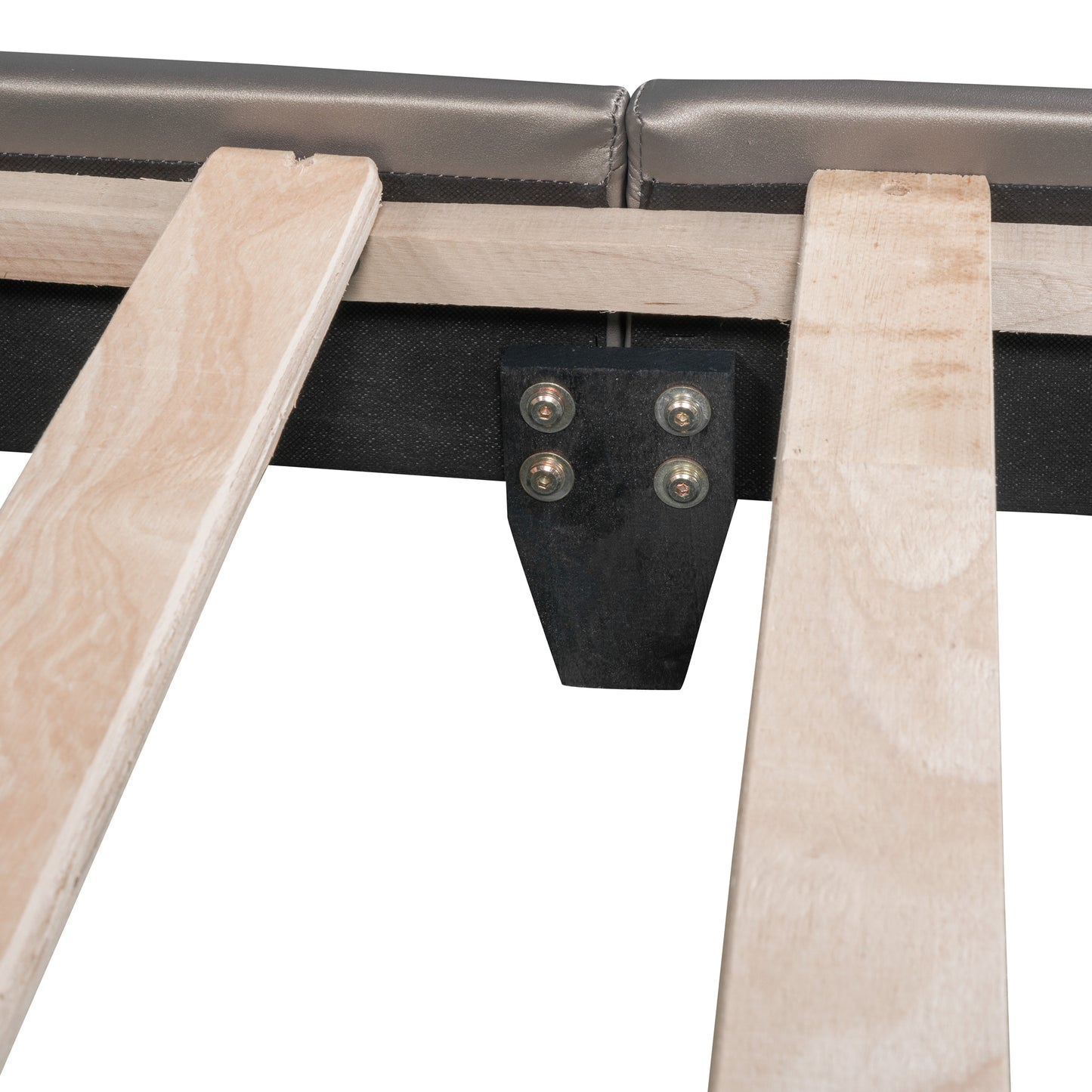Closeup of a wooden bed frame slat with a silver upholstered headboard