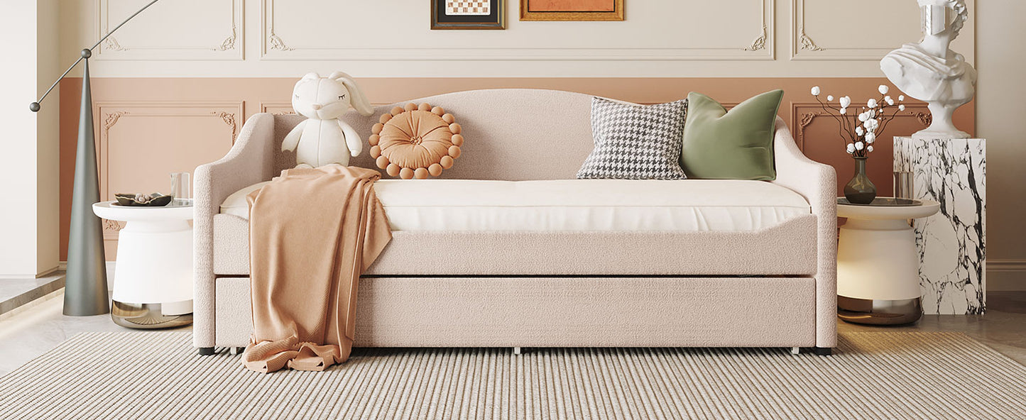 Tufted pink daybed with pullout trundle and soft throw blankets