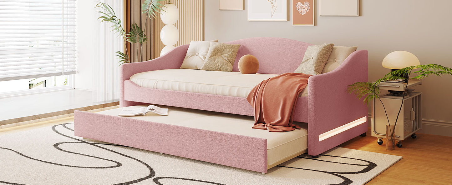 Pink upholstered daybed with pullout trundle