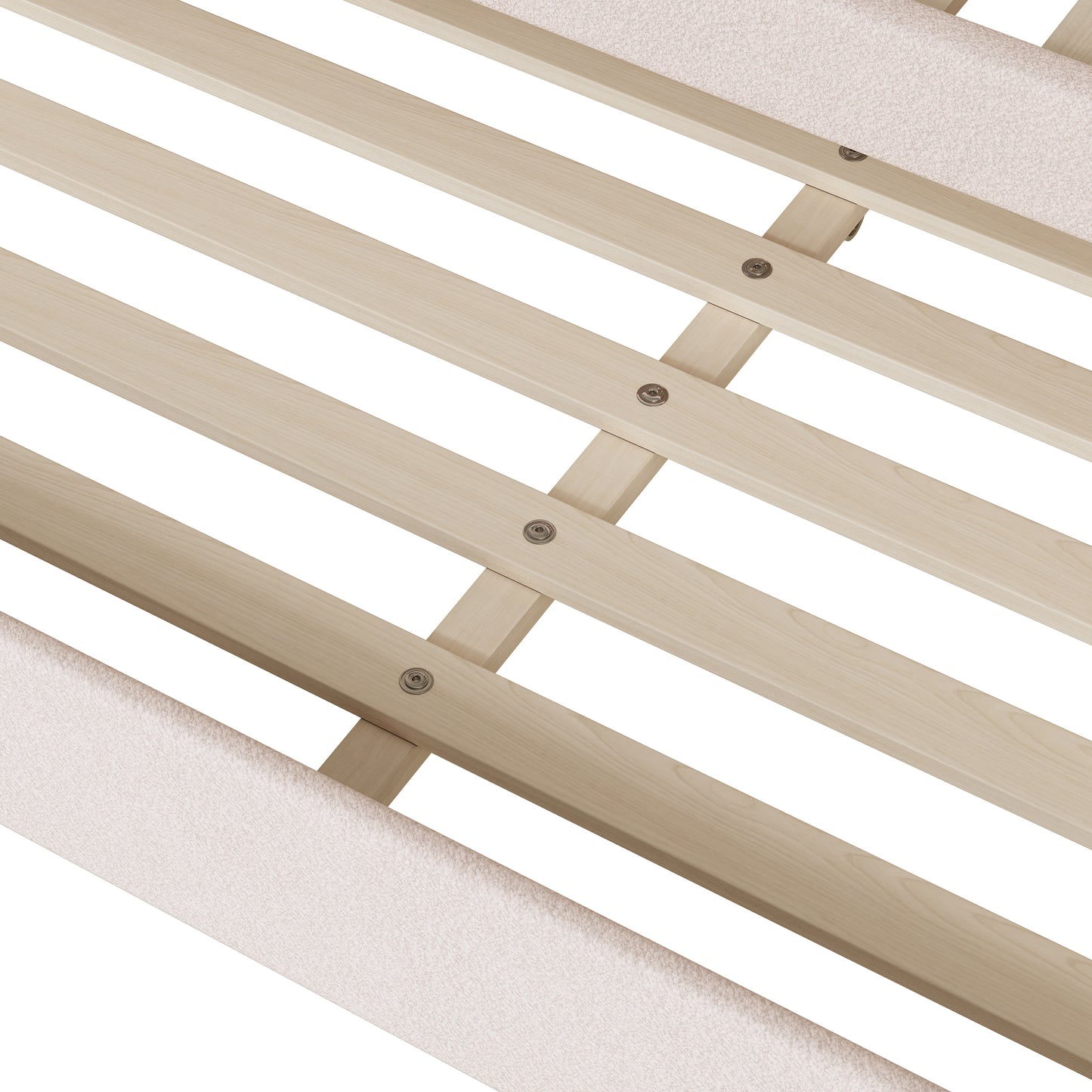 Closeup of a wooden bed frame with light beige upholstered side rails