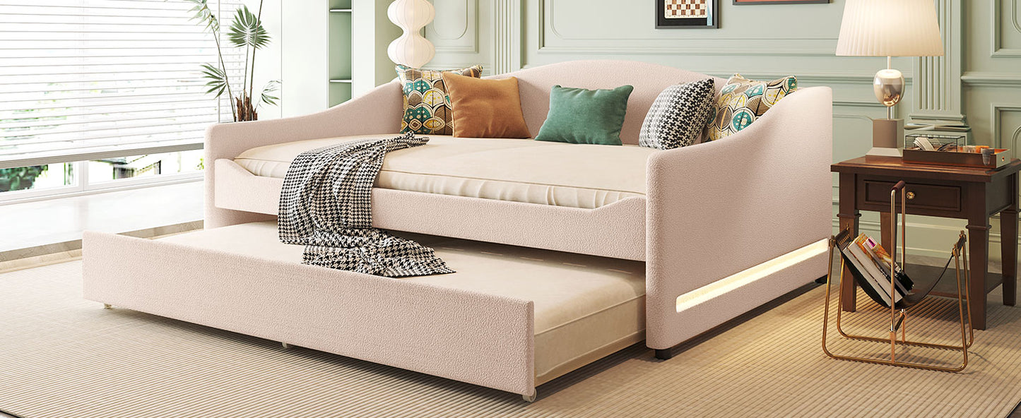 Pink boucle daybed with pullout trundle and decorative pillows