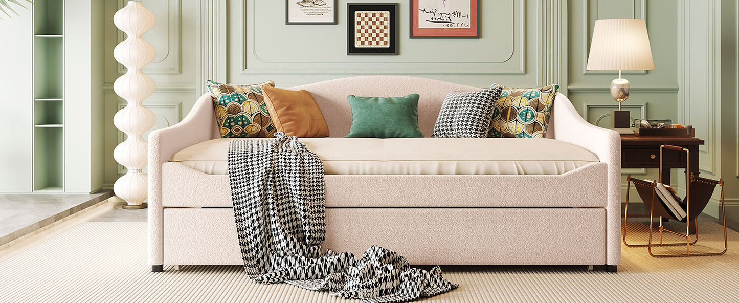 Modern pink boucle daybed with pullout trundle and decorative pillows