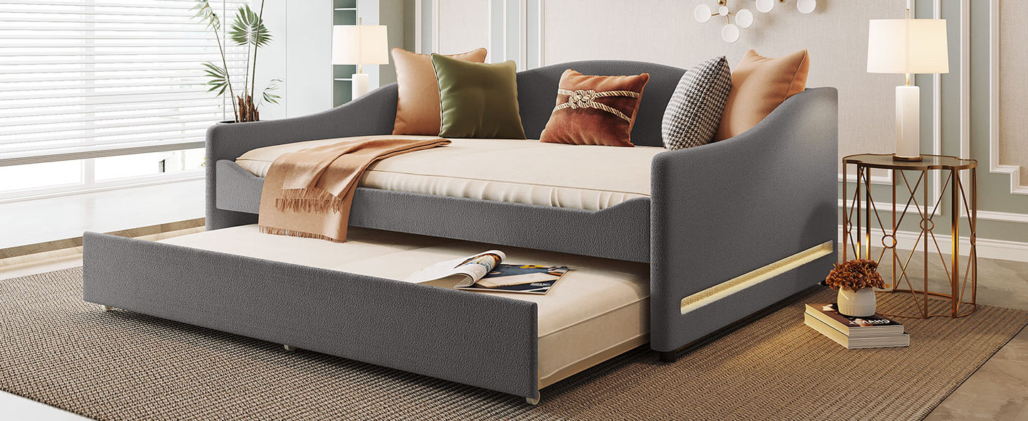 Grey upholstered daybed with pullout trundle perfect for guest rooms