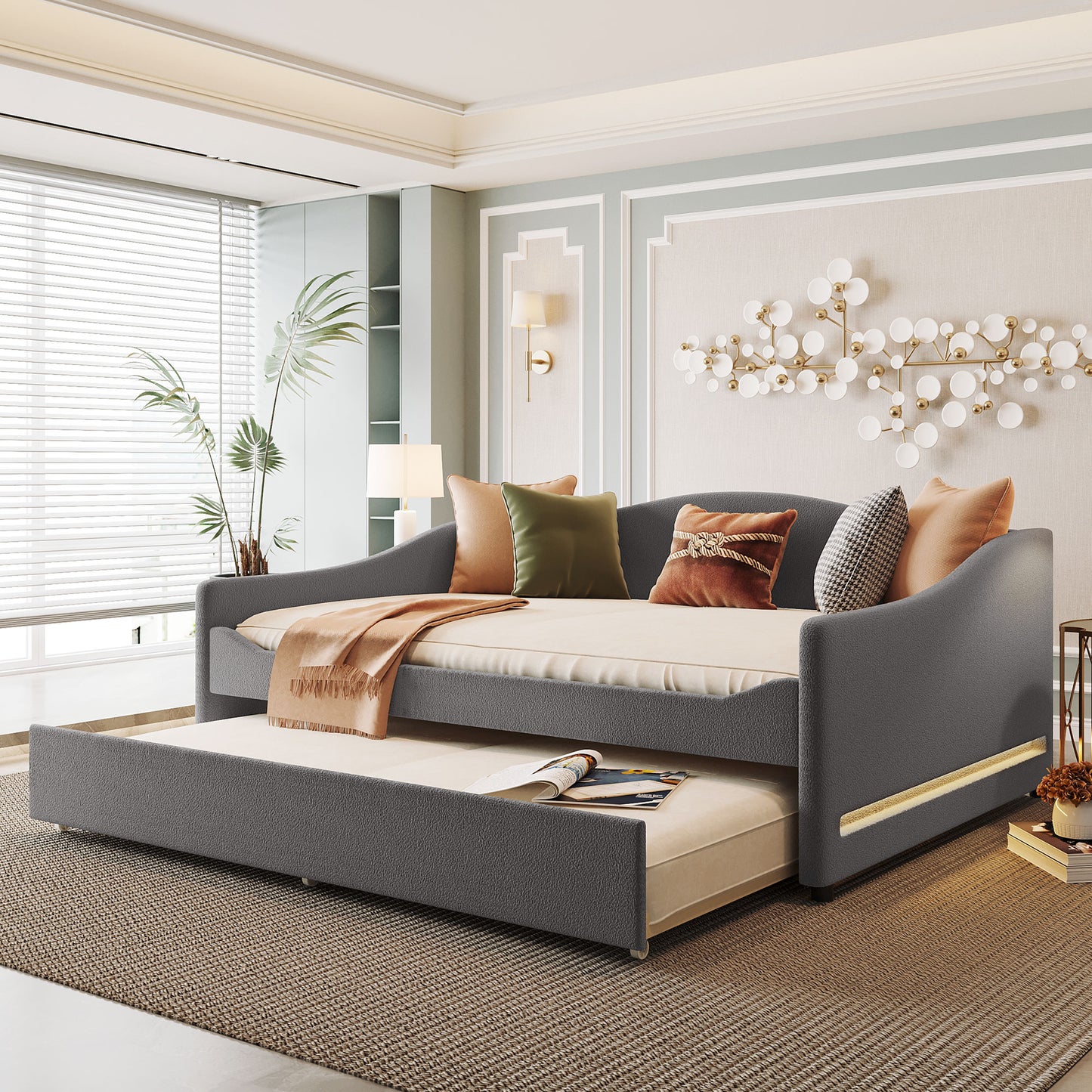 Dark gray upholstered daybed with trundle and accent pillows