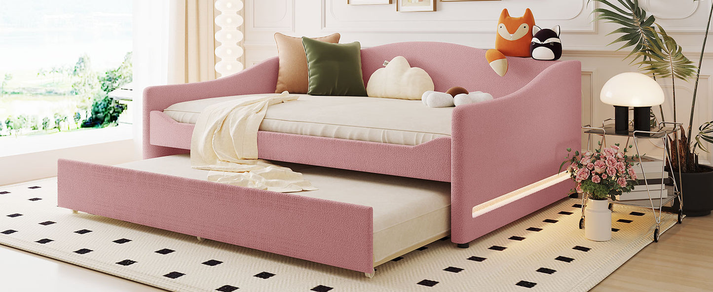 Pink upholstered daybed with pullout trundle ideal for kids rooms