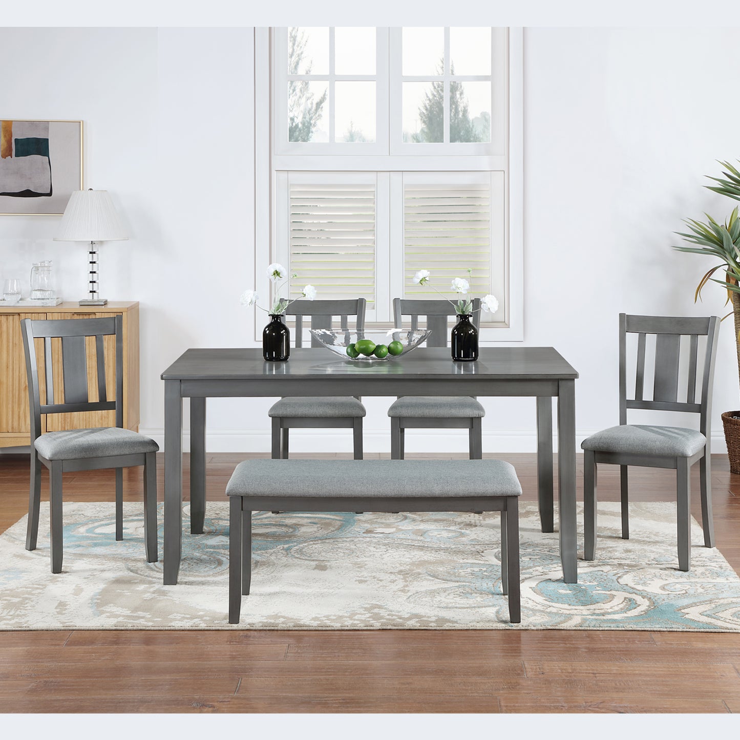 Gray dining table and chair set with upholstered seating