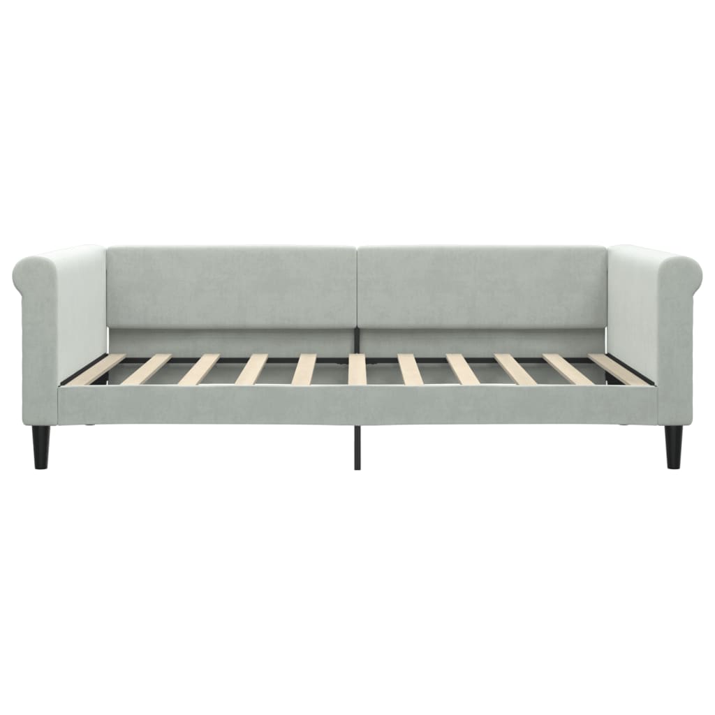 Light grey upholstered daybed with diamond tufting on arms and a slatted frame