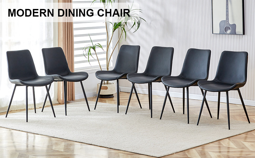 Black leather dining chairs with metal legs on rug