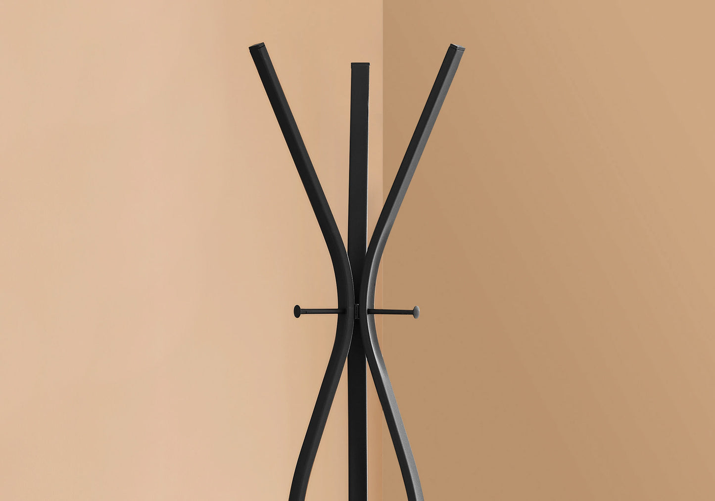 Black metal modern coat rack with curved legs and three hooks