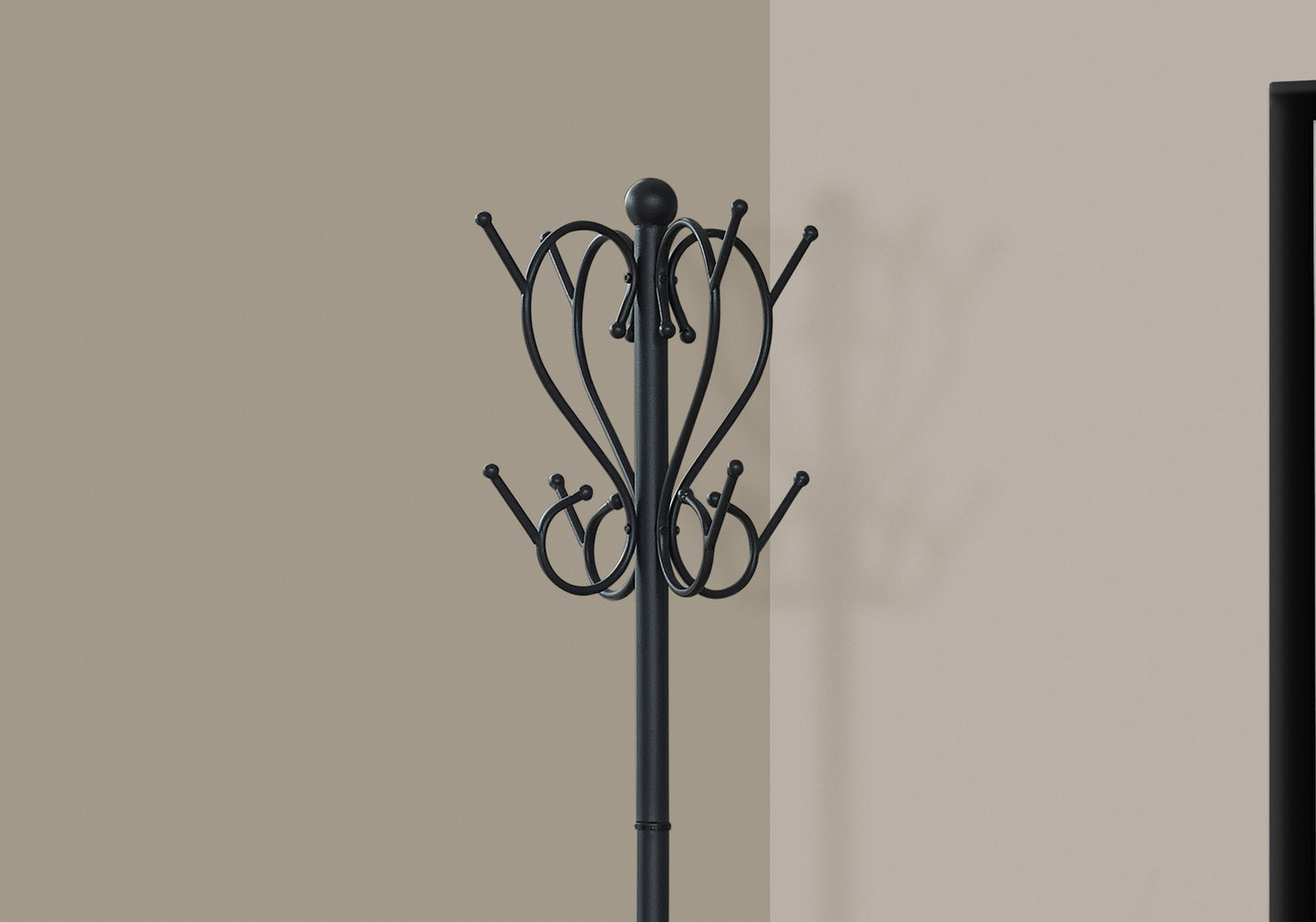 Black metal coat rack with ornate scroll design and multiple hooks