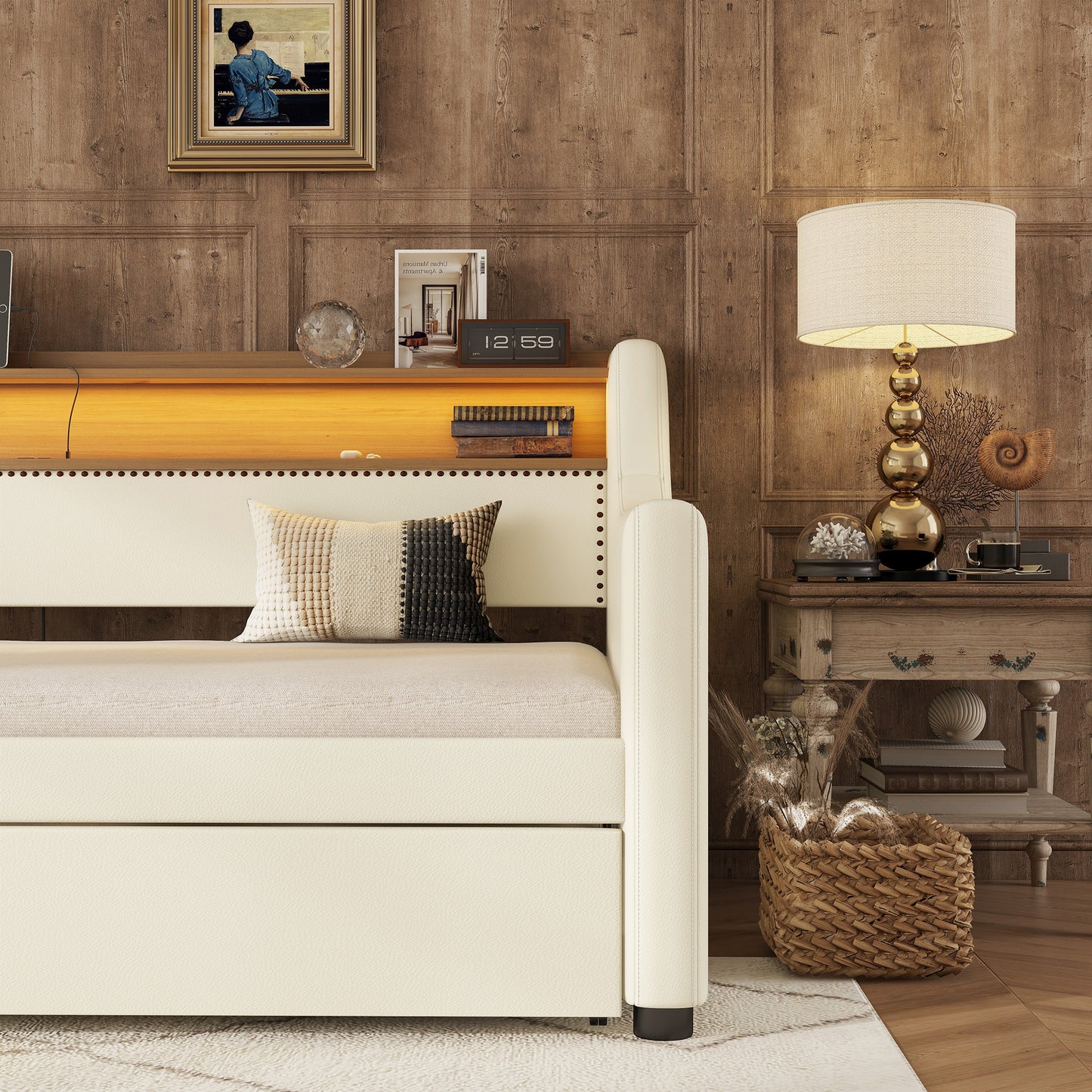 Cream upholstered sofa with decorative nailhead trim and striped throw pillow