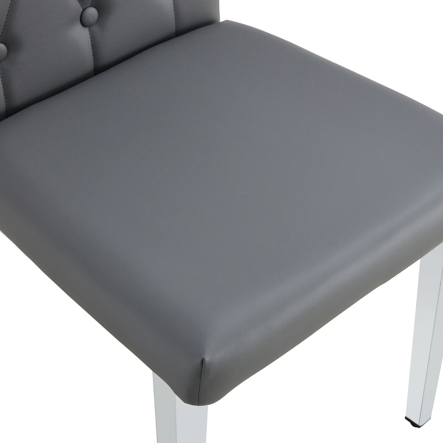 Gray faux leather dining chair with tufted back