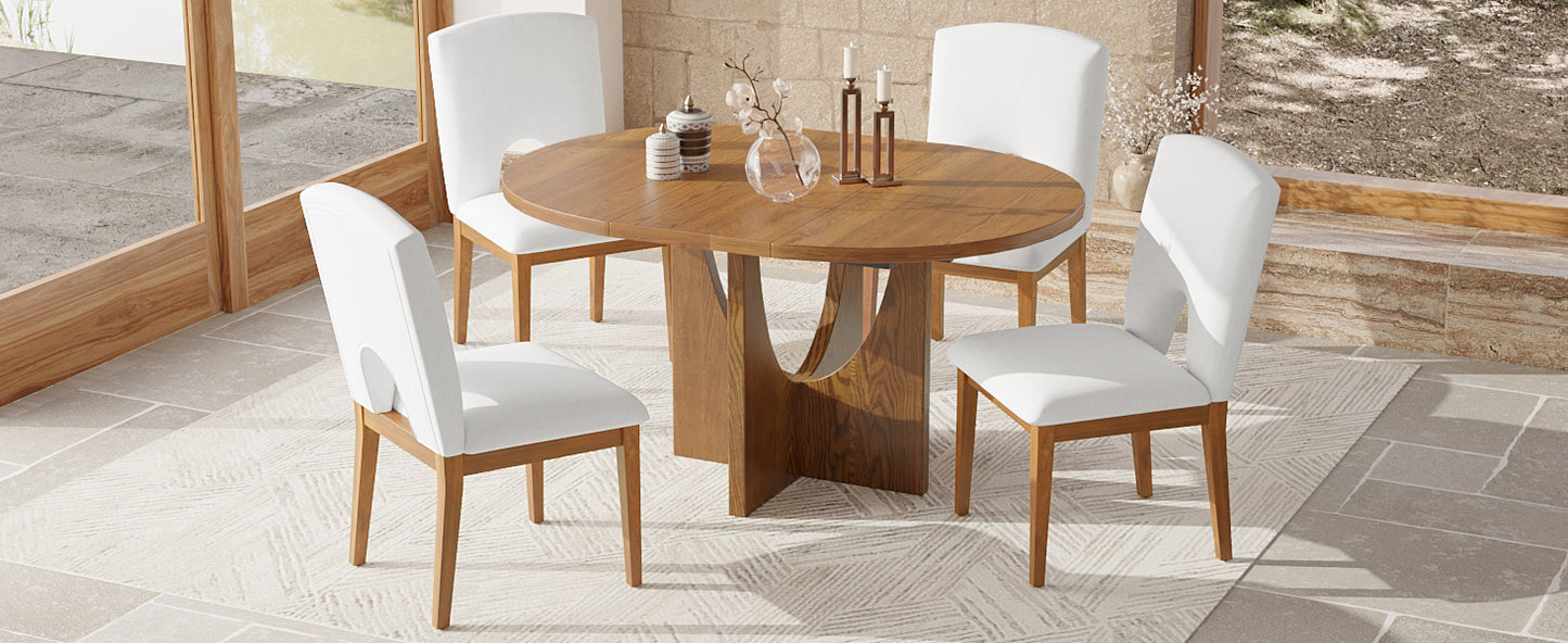 Round oak dining table with four white upholstered chairs