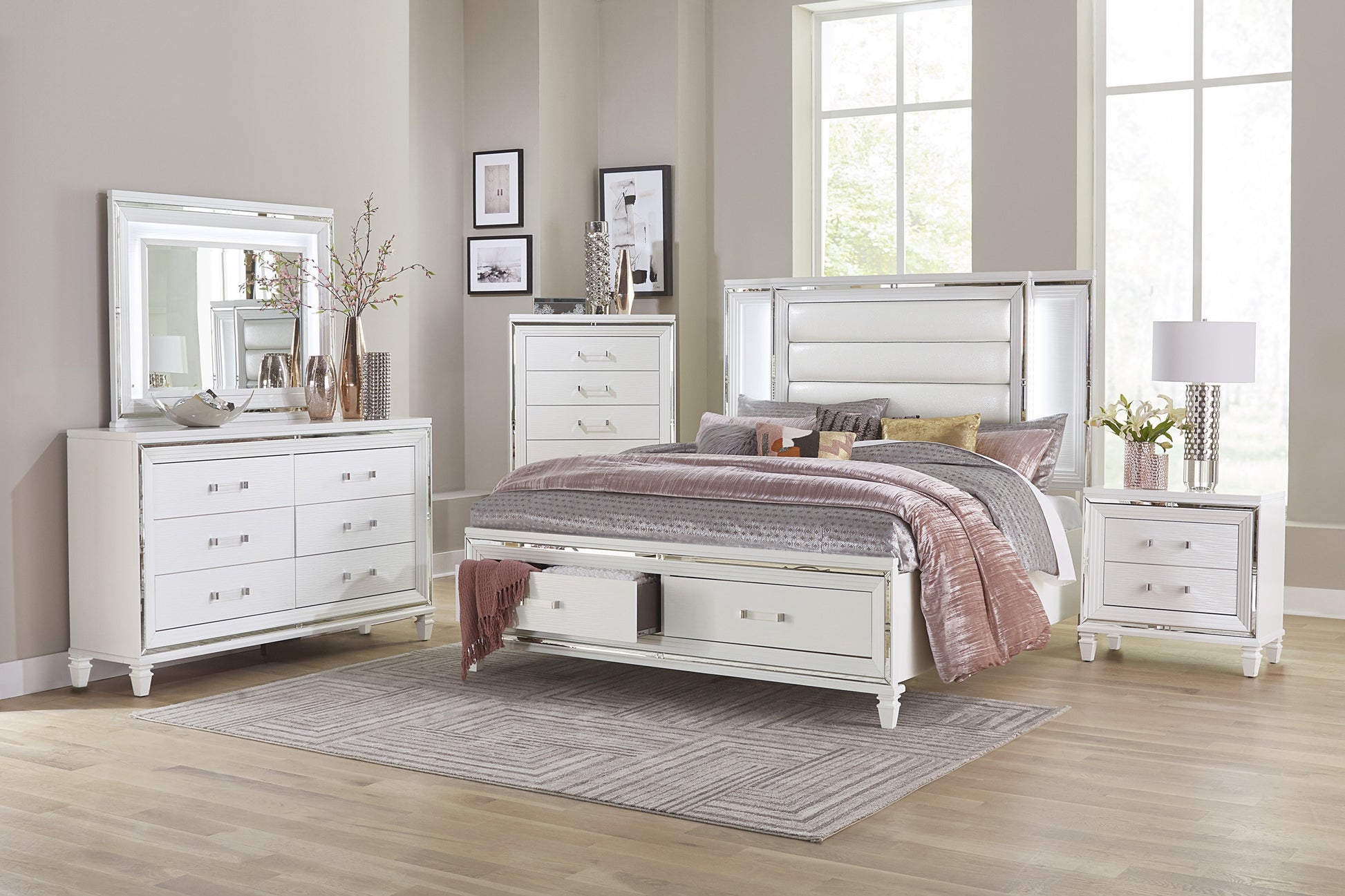 White upholstered queen bed with mirrored trim and builtin storage drawers