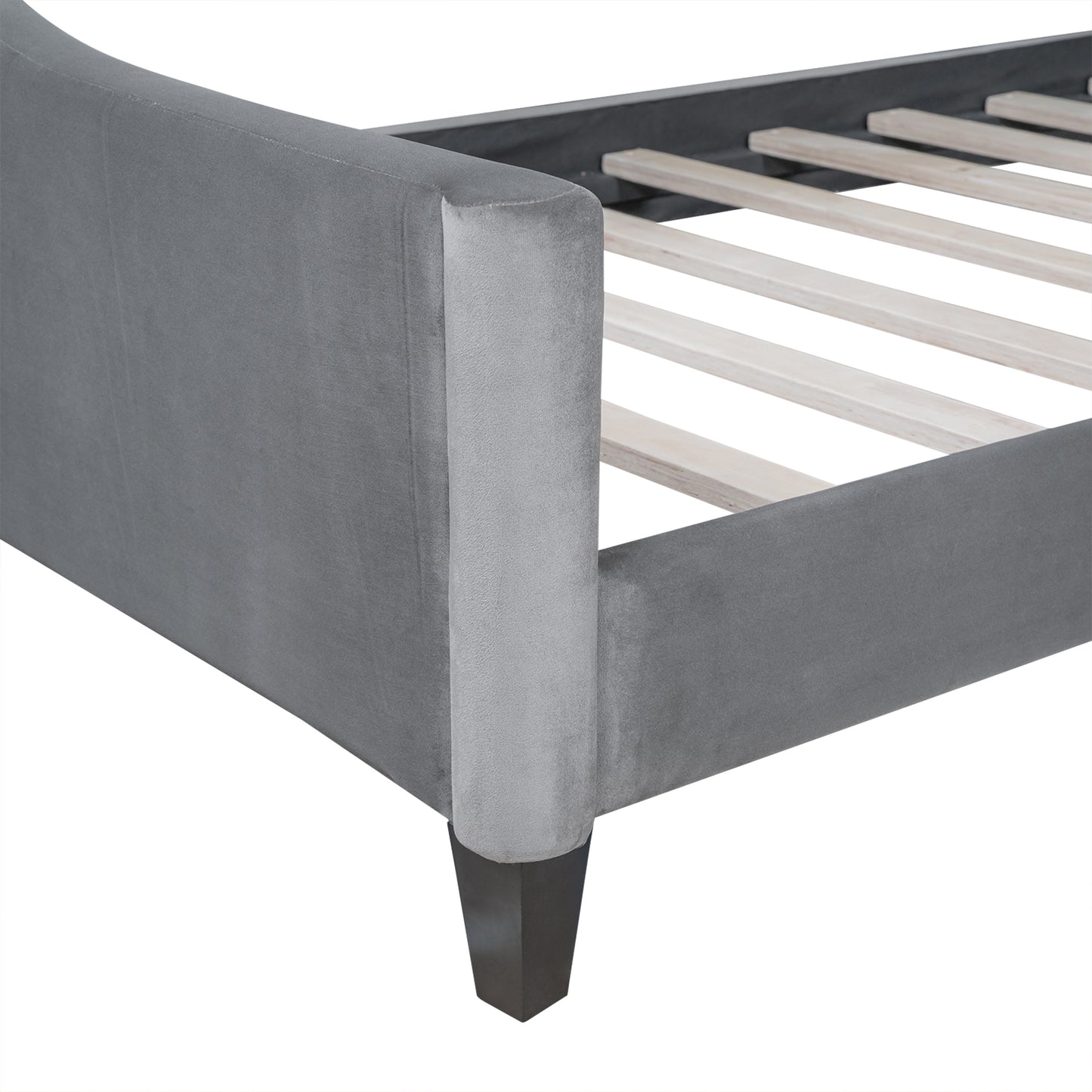 Grey velvet upholstered bed frame showing curved headboard and wooden slats