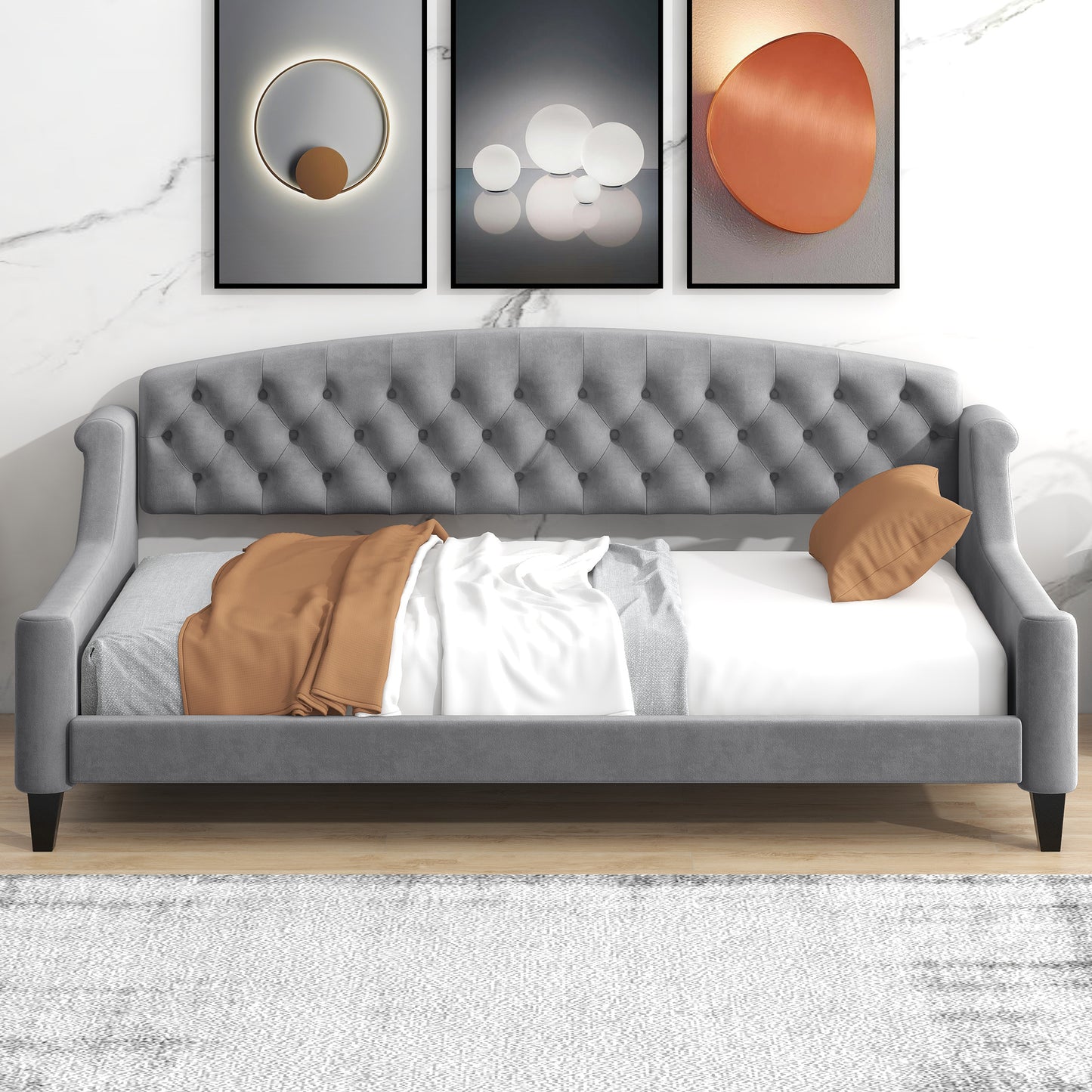 Grey velvet tufted daybed with rolled arms and a copper accent pillow