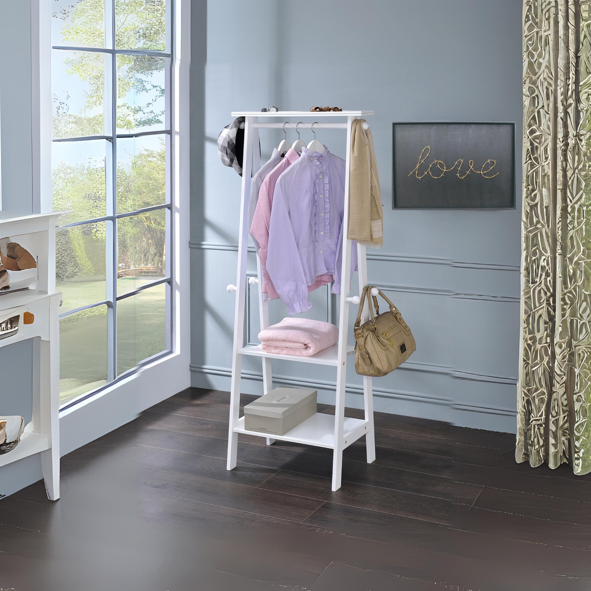 White wooden coat rack with clothes and bag