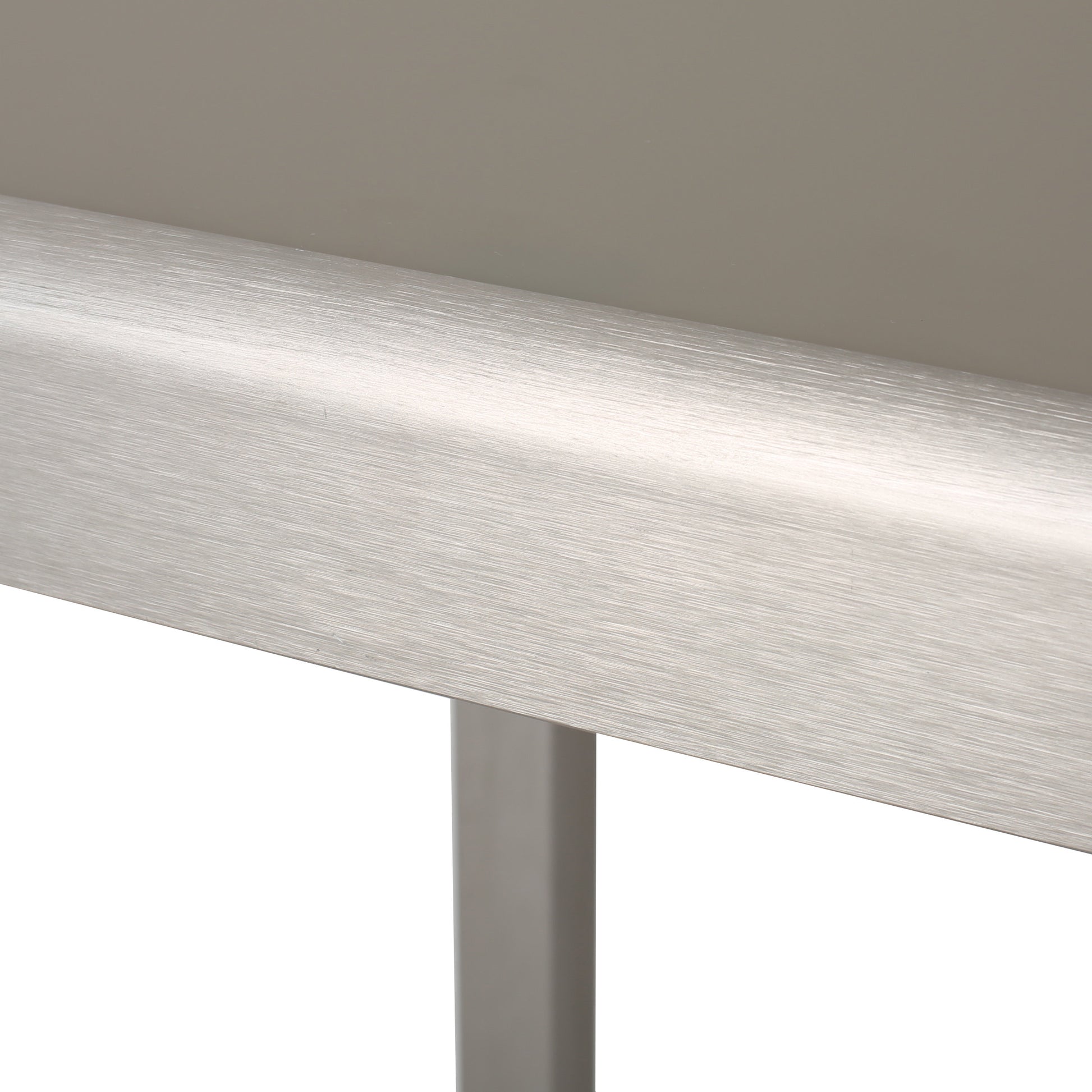 Brushed stainless steel bar accent on a modern desk