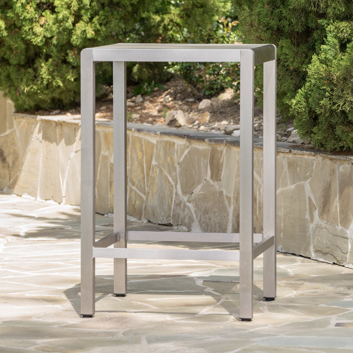Sleek silver metal bar stool with a modern minimalist design for outdoor patios