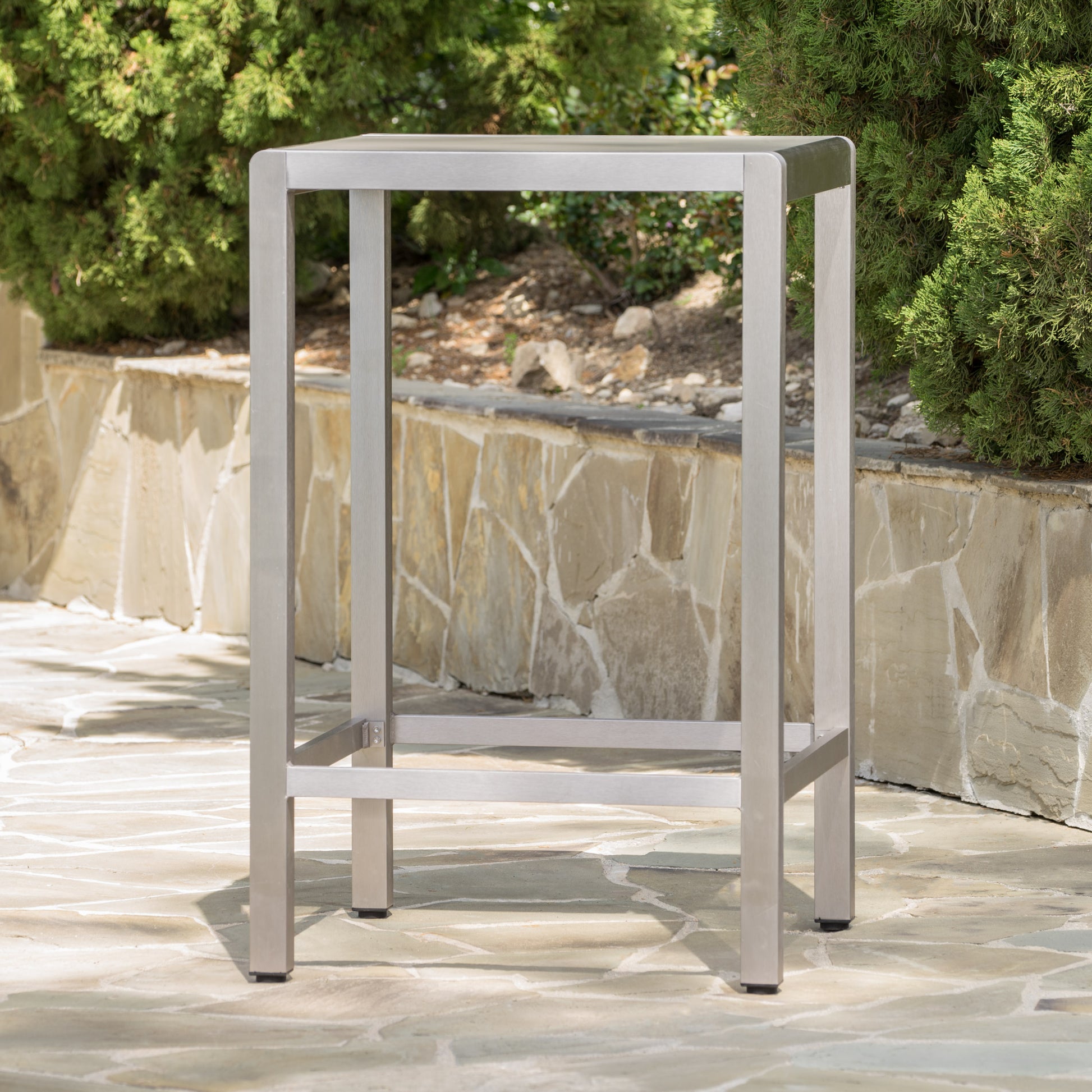 Sleek silver metal bar stool with a modern minimalist design for outdoor patios