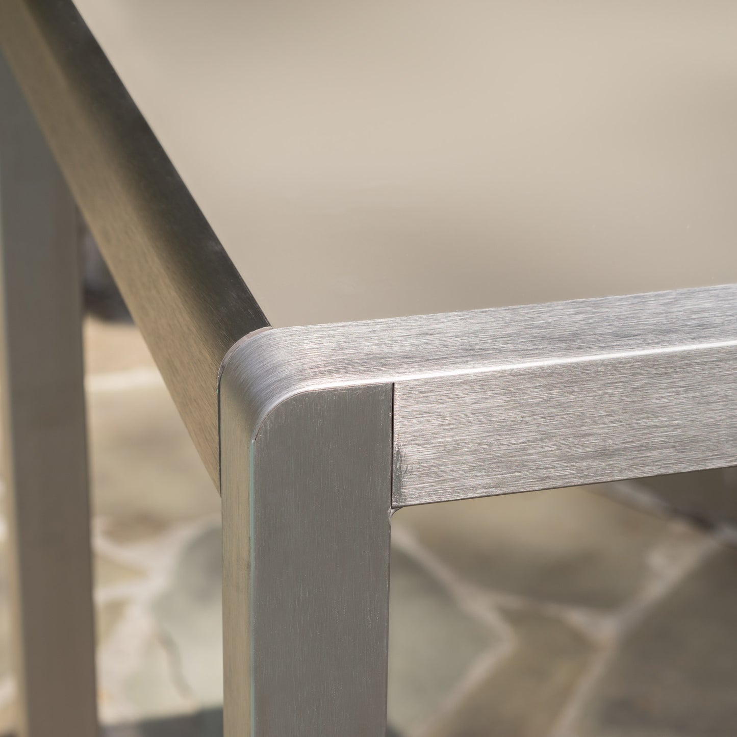 Brushed metal corner detail of a modern coffee table