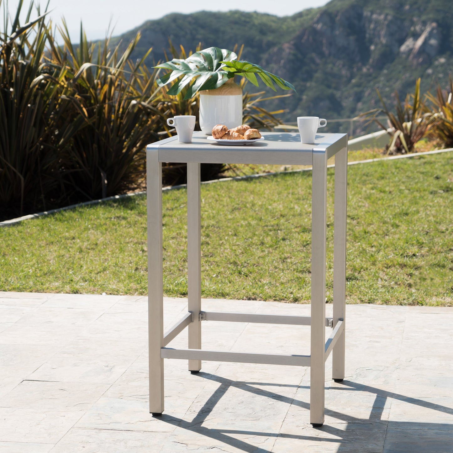 Modern grey aluminum outdoor bar table with clean lines and a smooth surface