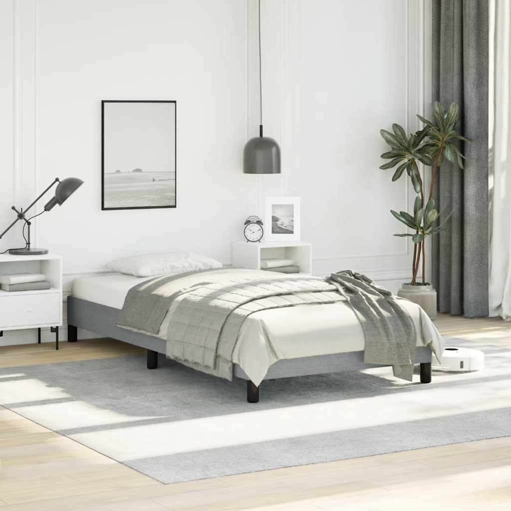 Grey upholstered twin bed frame with wooden slats