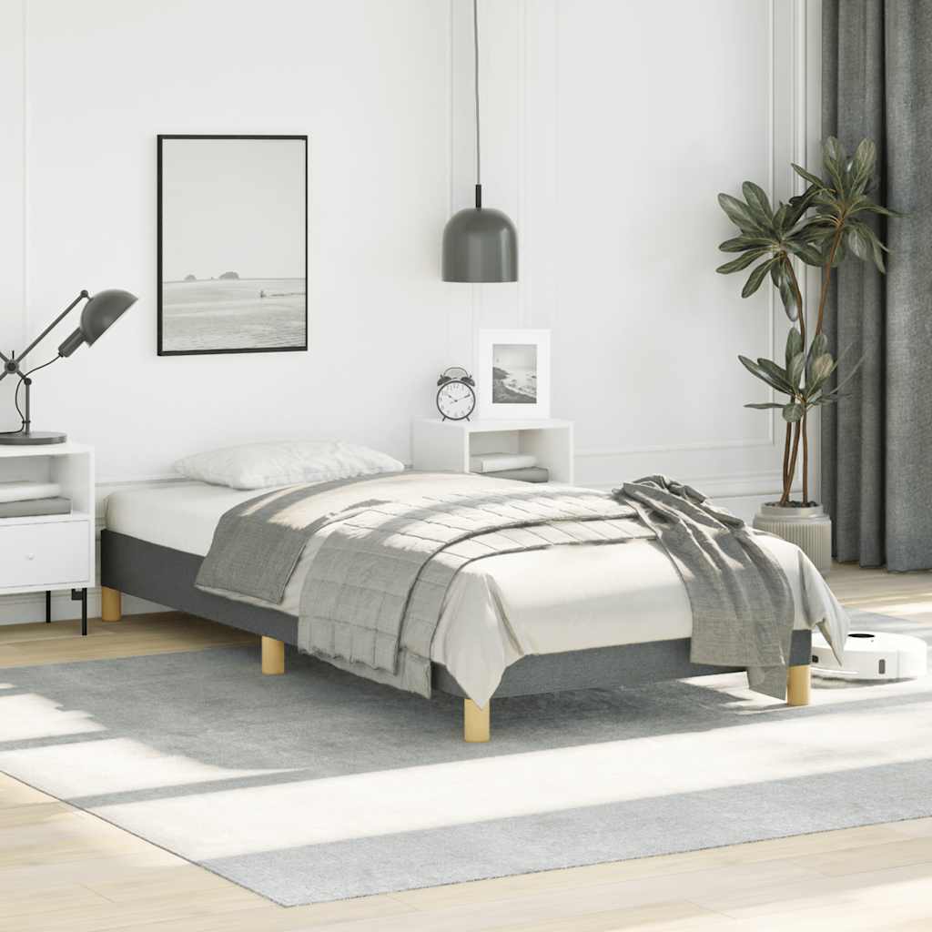 Dark grey upholstered bed frame with wooden slats and gold legs