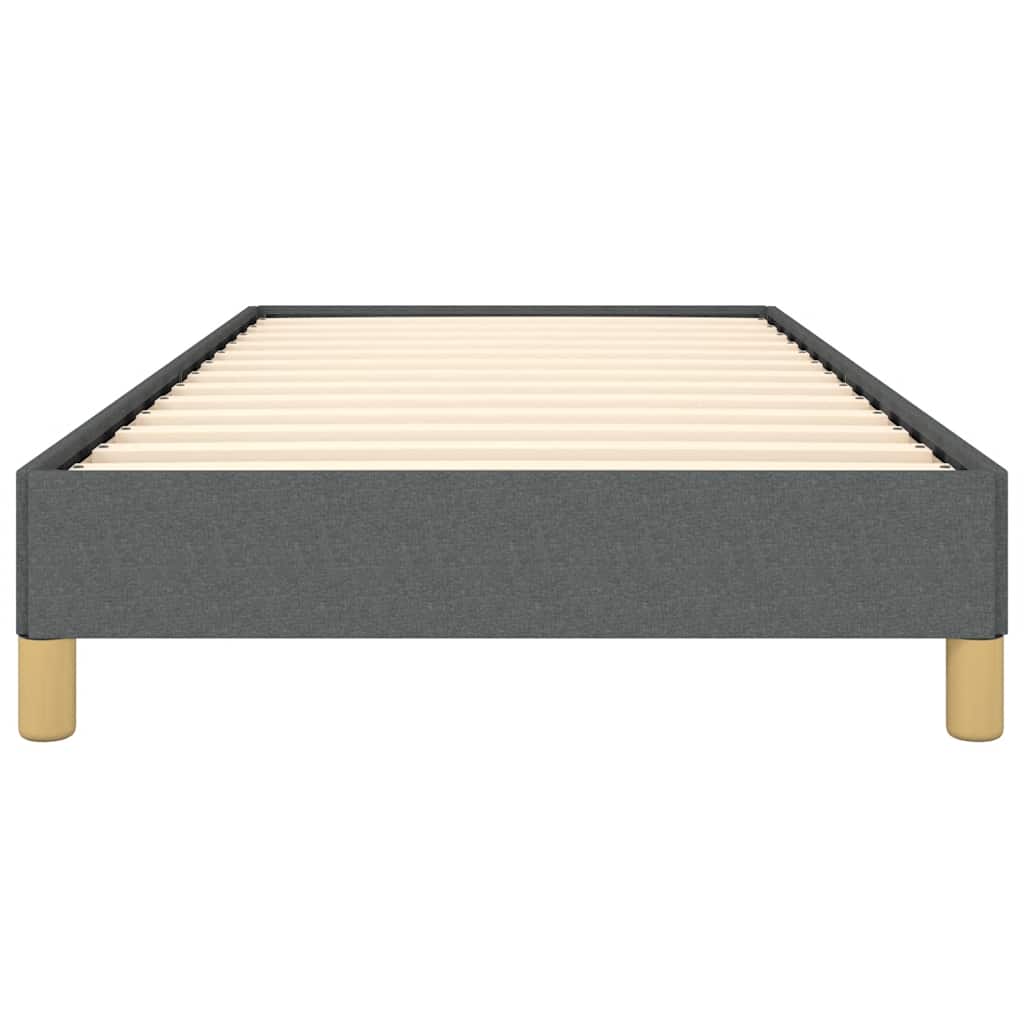 Modern upholstered bed frame in dark gray fabric with wooden slat support and gold tapered legs