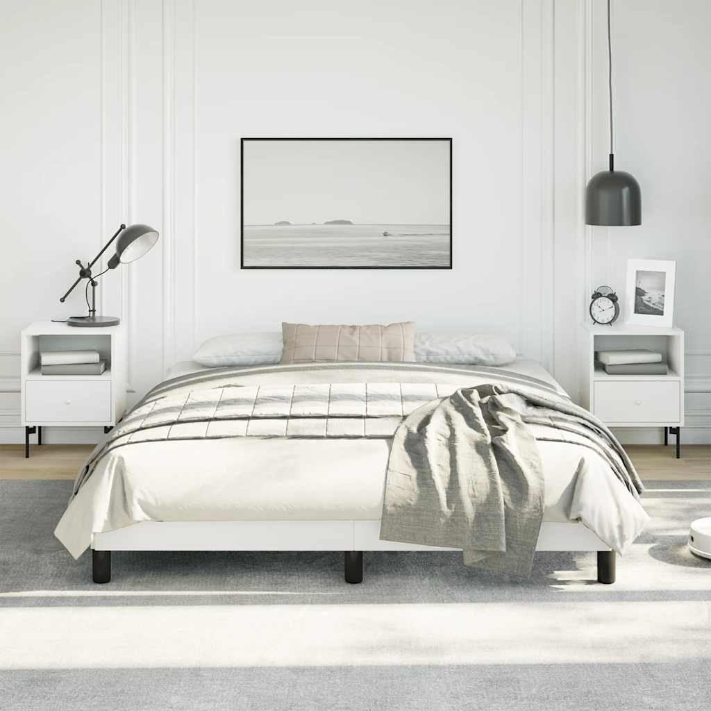 White platform bed frame with black legs and grey throw blanket