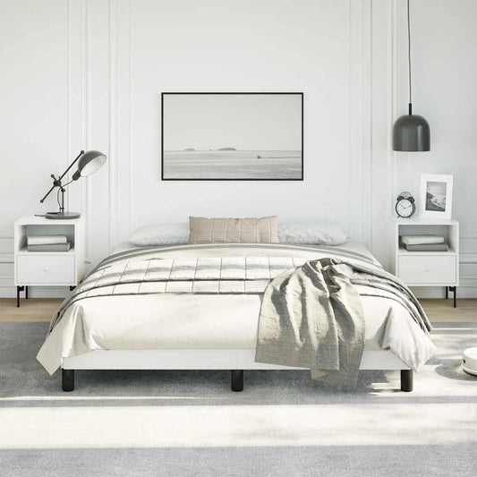 White platform bed frame with black legs and grey throw blanket