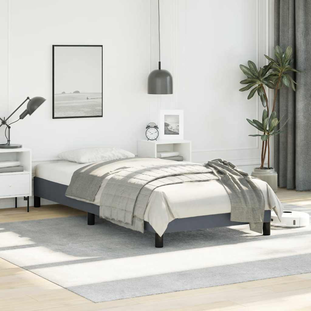 Modern twin bed frame with a grey upholstered base and a white mattress