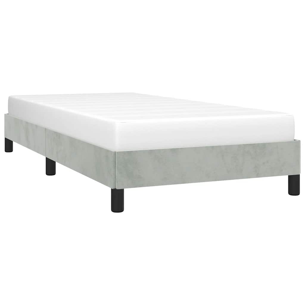 Single bed frame with grey upholstery and a white mattress