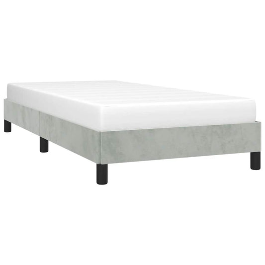 Single bed frame with grey upholstery and a white mattress