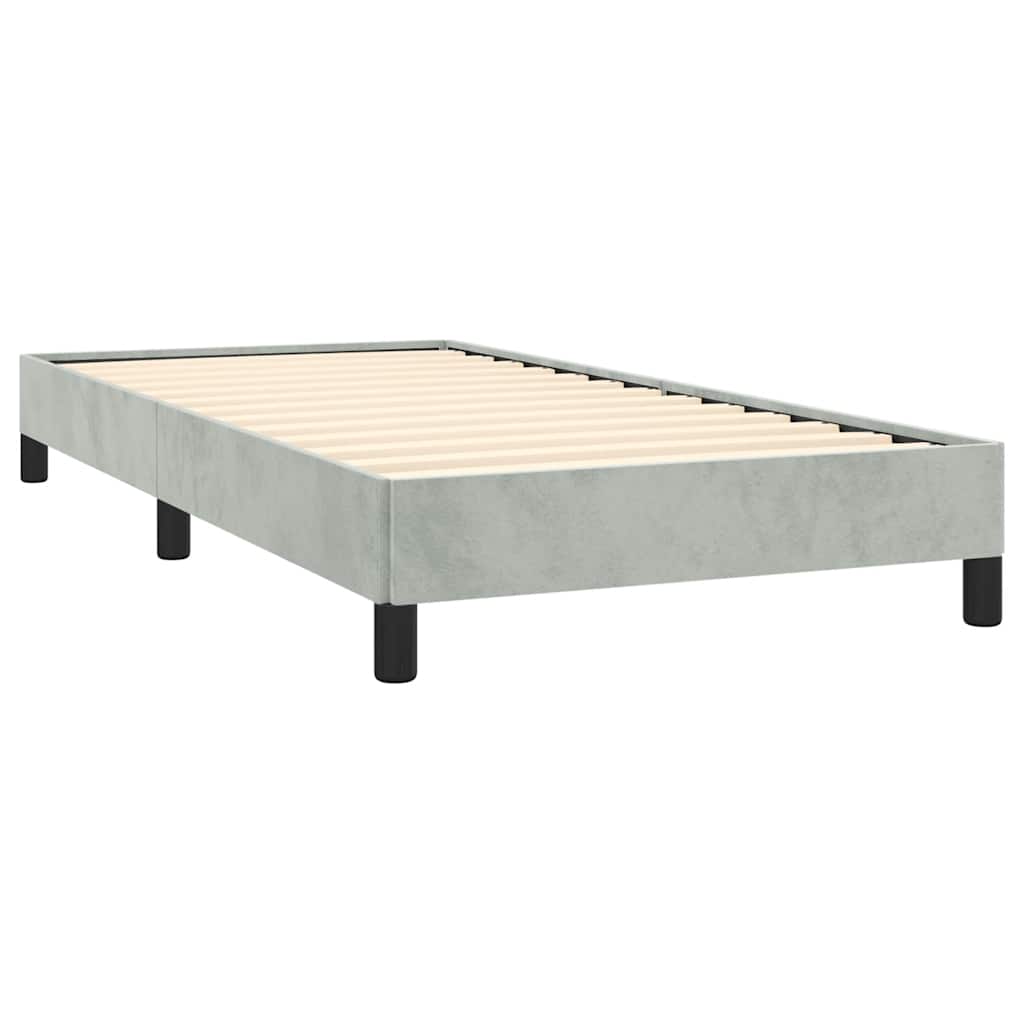 Modern grey upholstered bed frame with white mattress