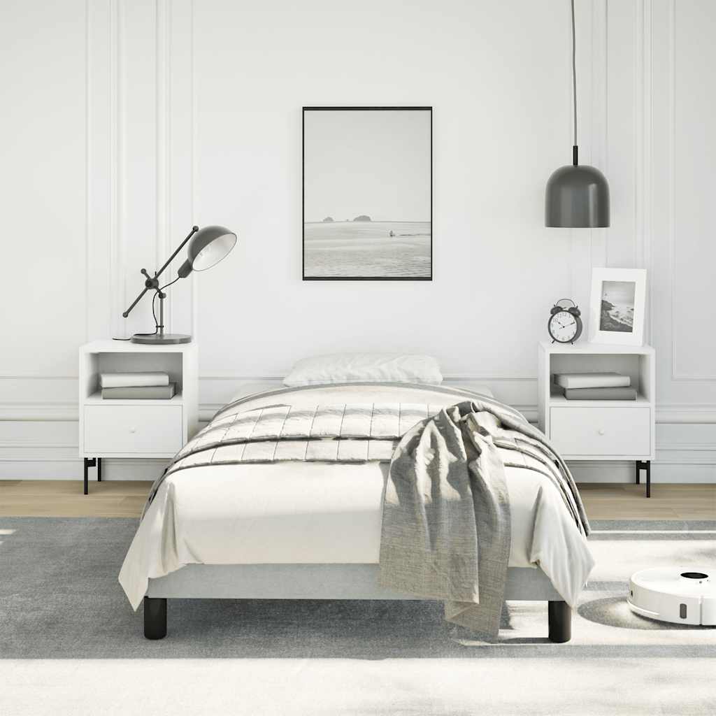 Light gray upholstered twin bed frame with wooden slats and black legs