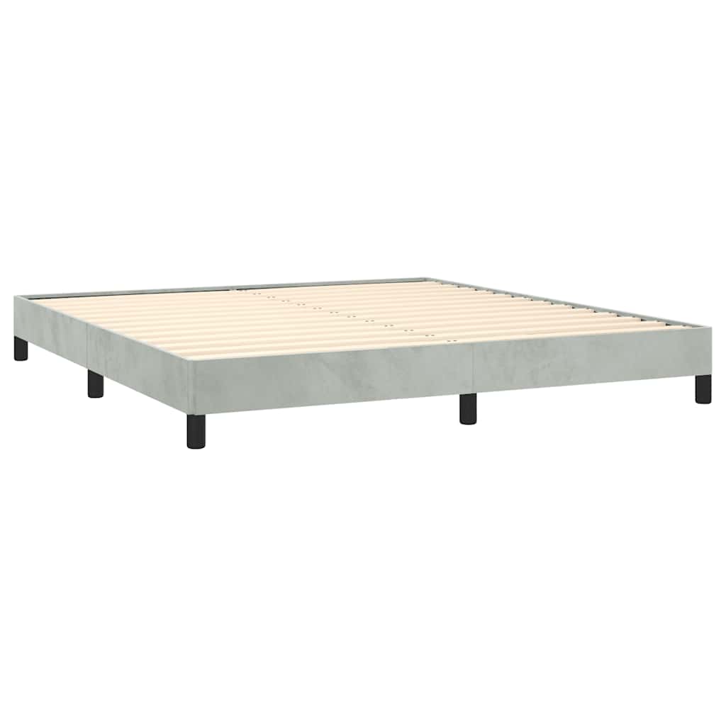 Light grey velvet upholstered bed frame with black legs and white mattress