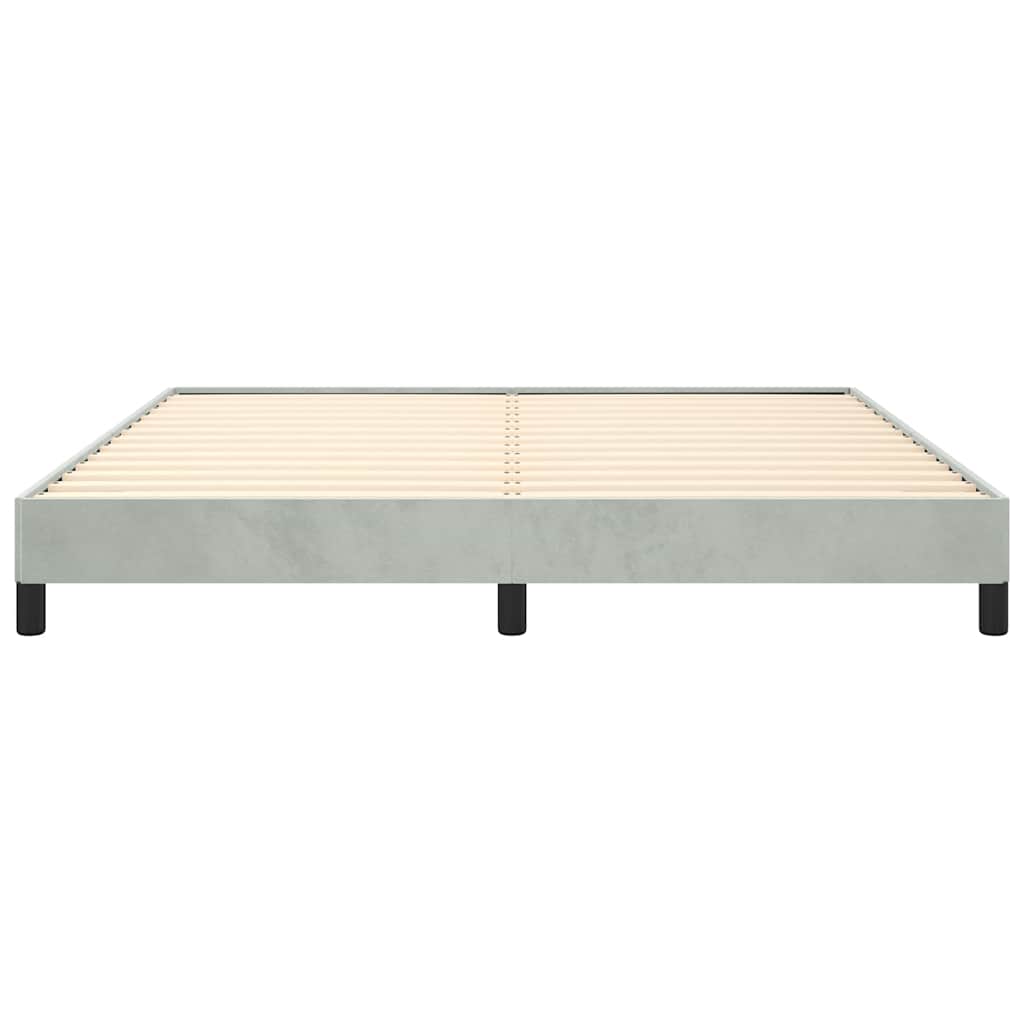 Modern minimalist metal bed frame with grey upholstery and crisp white bedding